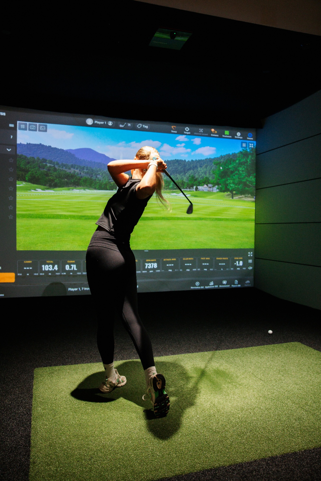 Golfer hitting an approach iron.